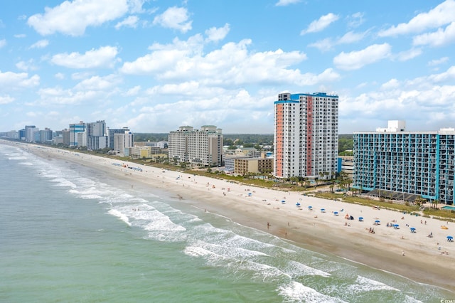 bird's eye view featuring a view of city, a beach view, and a water view