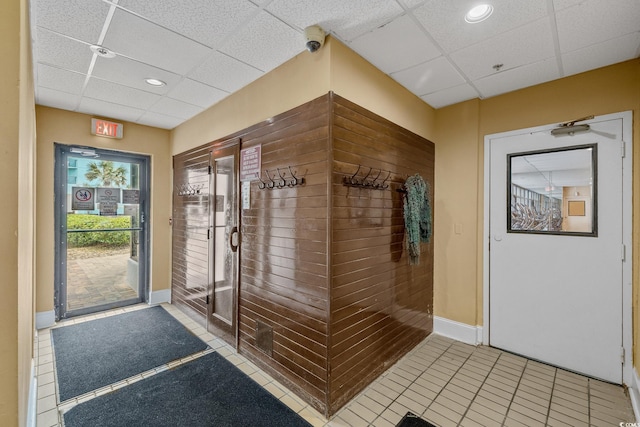 interior space featuring recessed lighting, a drop ceiling, baseboards, and tile patterned floors