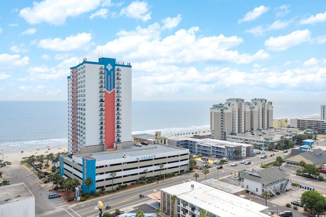 exterior space featuring a view of the beach, a view of city, and a water view