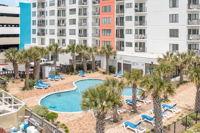 pool featuring a patio area and fence