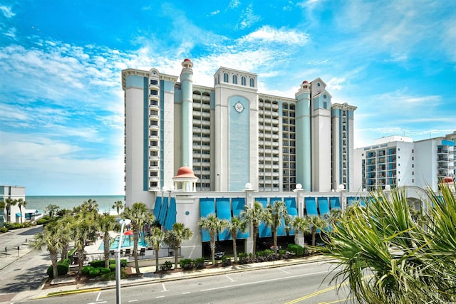 view of building exterior featuring a view of city and a water view