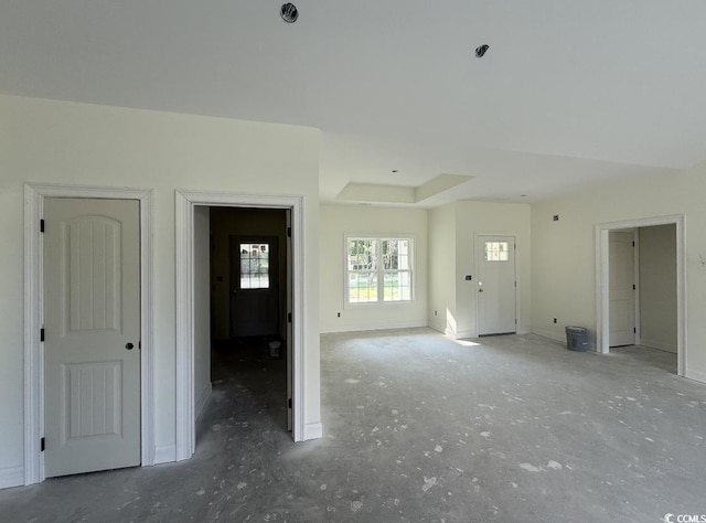 6049 Hodges Rd, Conway, SC 29527 - unfurnished living room featuring baseboards and a tray ceiling