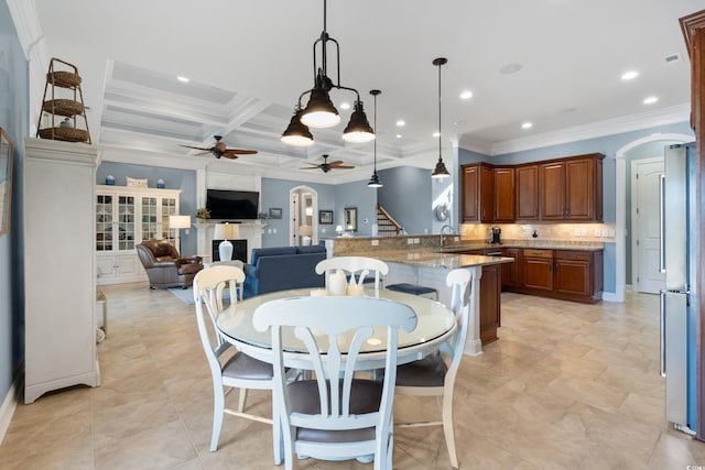 dining space featuring arched walkways, beam ceiling, stairway, ceiling fan, and coffered ceiling