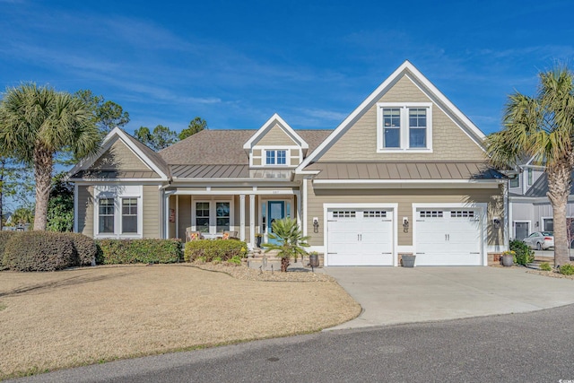 craftsman-style house with a standing seam roof, a porch, concrete driveway, and a garage