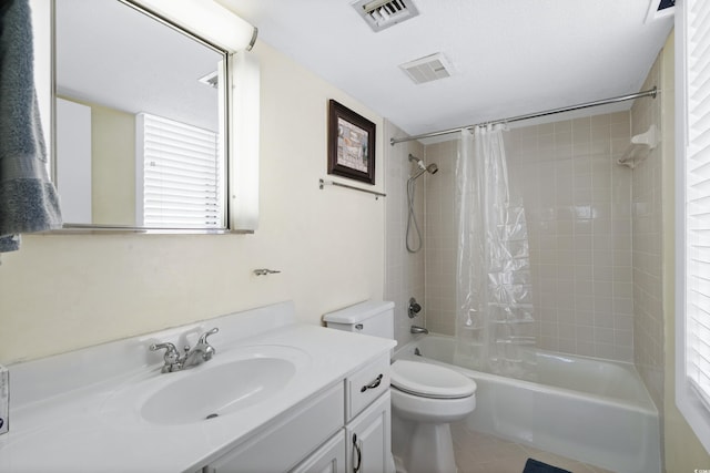 full bathroom with visible vents, vanity, toilet, and shower / bath combo with shower curtain