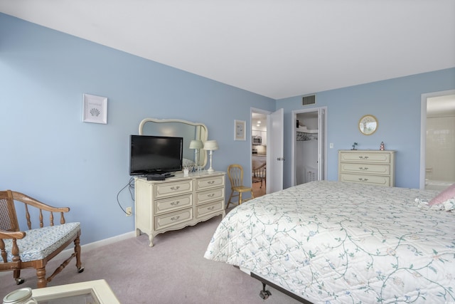 bedroom featuring baseboards, visible vents, carpet flooring, and ensuite bathroom