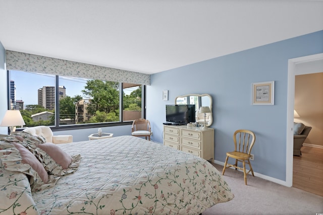 carpeted bedroom featuring baseboards