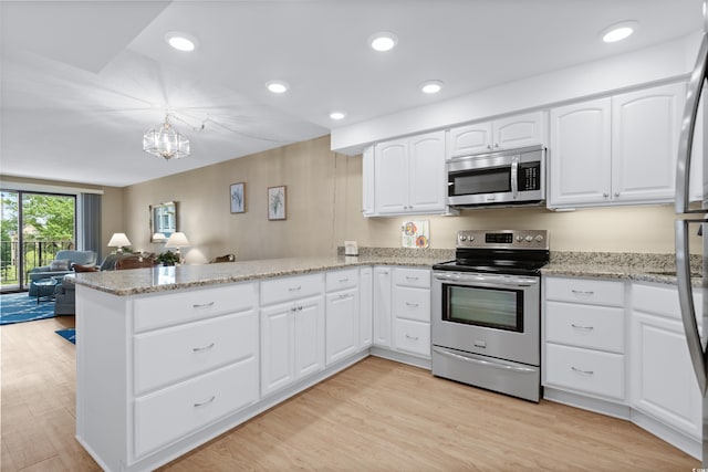 kitchen featuring light wood-style flooring, light stone counters, open floor plan, a peninsula, and stainless steel appliances