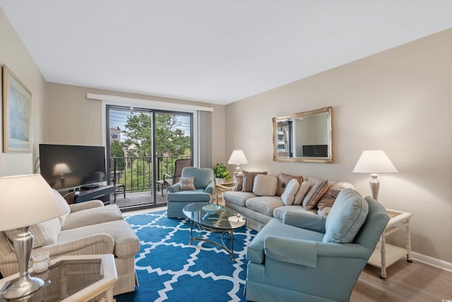 living room featuring baseboards and wood finished floors