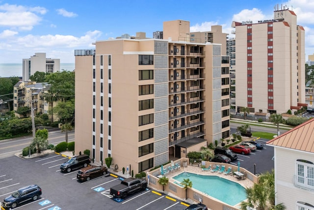 view of building exterior with a view of city and uncovered parking