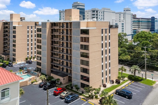 view of building exterior featuring a view of city and uncovered parking