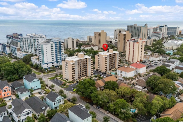 birds eye view of property with a water view and a city view