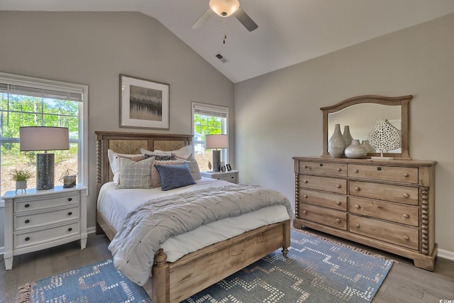 bedroom featuring a ceiling fan, lofted ceiling, wood finished floors, and visible vents