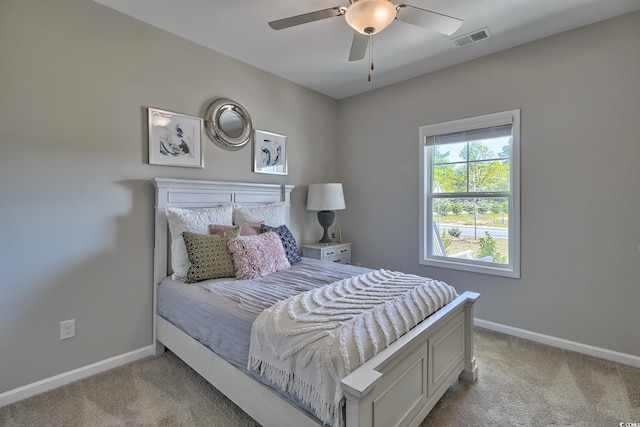 bedroom featuring light carpet, visible vents, a ceiling fan, and baseboards