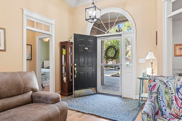 foyer entrance with a notable chandelier and wood finished floors