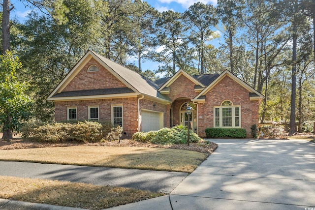 view of front of house featuring concrete driveway, brick siding, and an attached garage