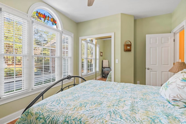 bedroom with a ceiling fan and baseboards