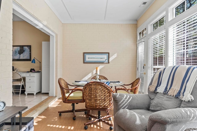 interior space with brick wall and wood finished floors