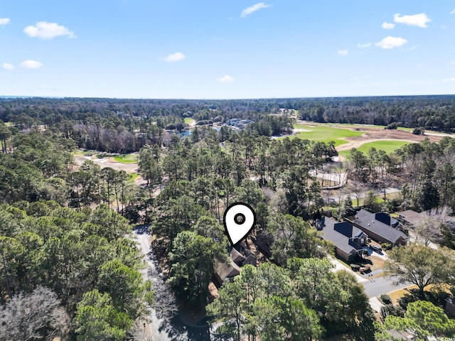 aerial view featuring view of golf course and a view of trees