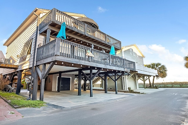 view of property featuring an attached garage and a carport