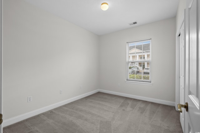 unfurnished bedroom featuring visible vents, light carpet, and baseboards