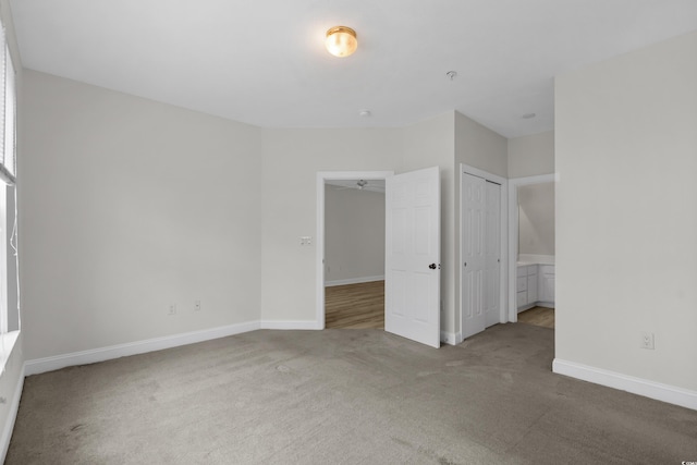 unfurnished bedroom with carpet and baseboards