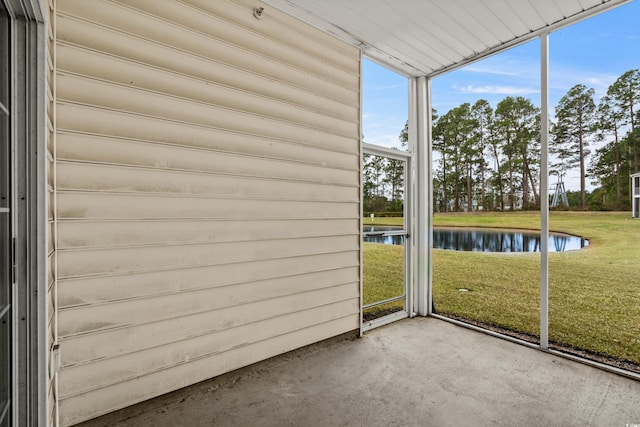 unfurnished sunroom with a water view