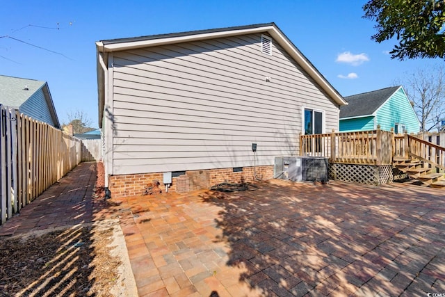 exterior space featuring a patio area, crawl space, a fenced backyard, and a wooden deck