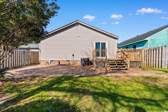 back of property with crawl space, a patio area, a lawn, and a fenced backyard