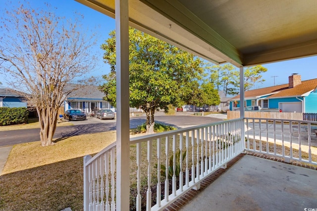 balcony featuring covered porch and a residential view