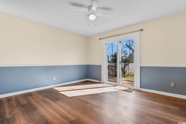 empty room featuring a textured ceiling, ceiling fan, wood finished floors, and baseboards