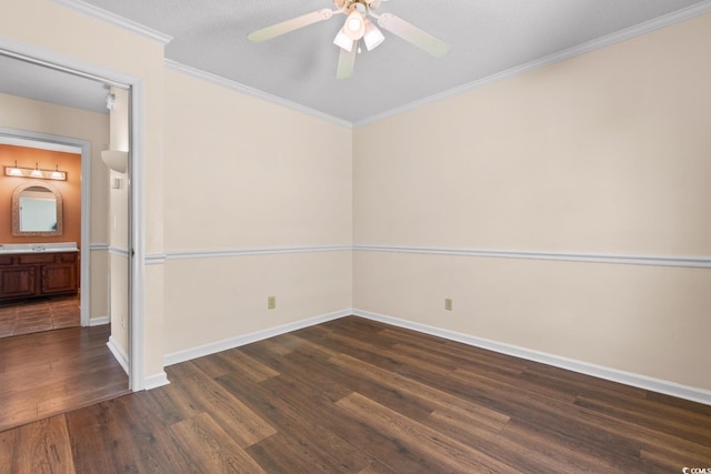 unfurnished room featuring dark wood-style floors, ornamental molding, baseboards, and ceiling fan