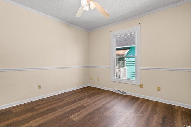 spare room featuring visible vents, dark wood finished floors, ceiling fan, ornamental molding, and a textured ceiling