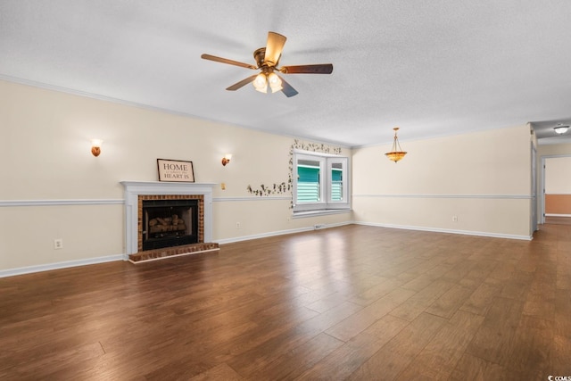 unfurnished living room with dark wood-style floors, ceiling fan, a textured ceiling, and a fireplace