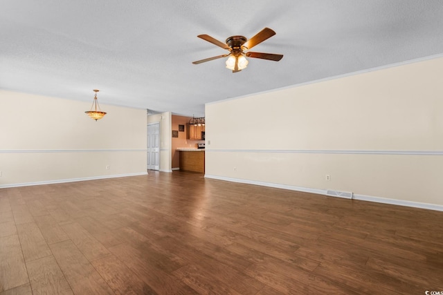 unfurnished living room with a ceiling fan, dark wood-style flooring, a textured ceiling, and baseboards