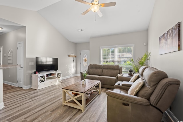 living area with vaulted ceiling, a ceiling fan, light wood finished floors, and baseboards