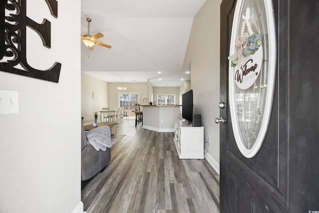 entrance foyer featuring ceiling fan, baseboards, and wood finished floors