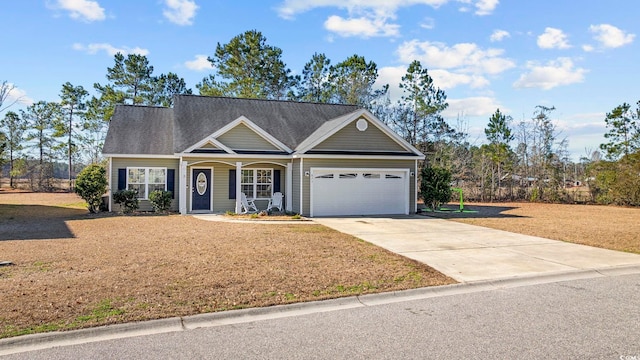 view of front of property featuring a garage, driveway, and a front yard