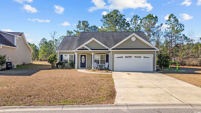 view of front of home with a garage, driveway, and a front lawn