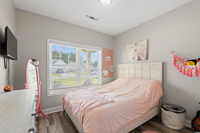 bedroom with dark wood-style floors and baseboards
