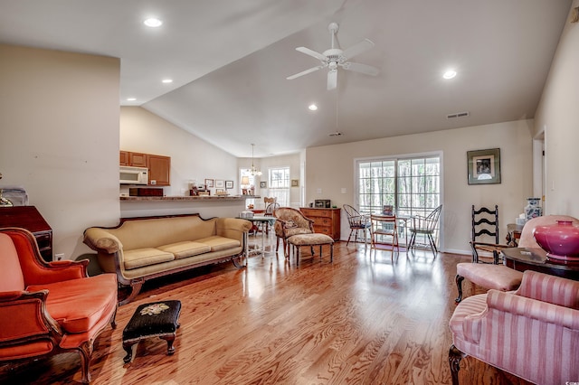 living room with high vaulted ceiling, recessed lighting, visible vents, a ceiling fan, and light wood-type flooring