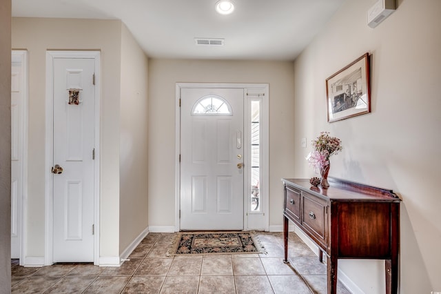 entrance foyer featuring baseboards, visible vents, and light tile patterned flooring