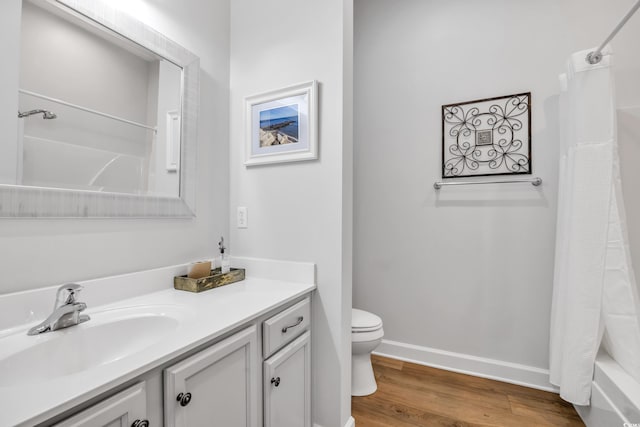 bathroom featuring shower / bathtub combination with curtain, toilet, wood finished floors, baseboards, and vanity