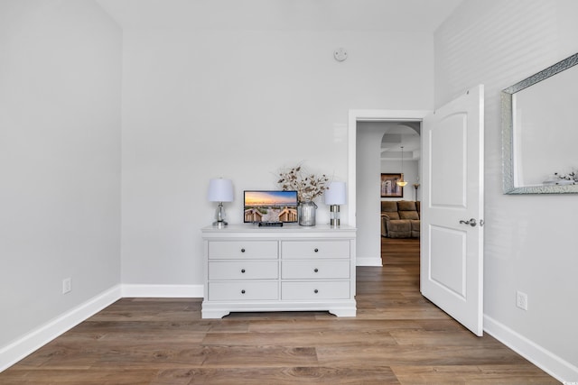 unfurnished bedroom with baseboards and wood finished floors