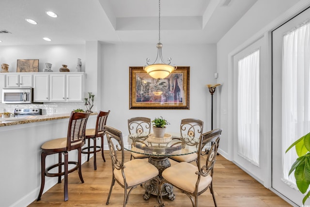 dining area with plenty of natural light, recessed lighting, and light wood finished floors