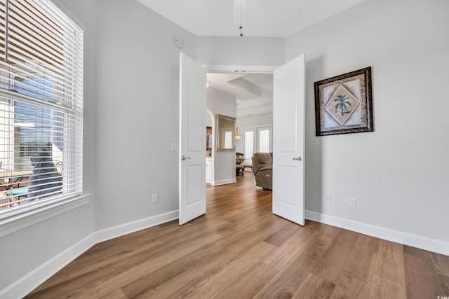 empty room with baseboards and light wood-style floors