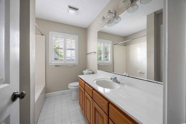 bathroom featuring tile patterned flooring, vanity, toilet, and a textured ceiling