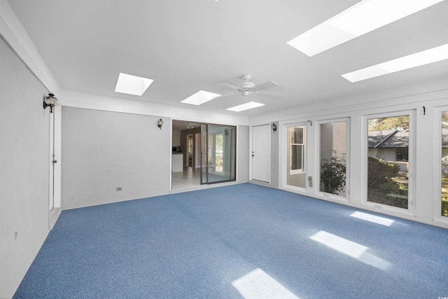 carpeted spare room with a ceiling fan and plenty of natural light