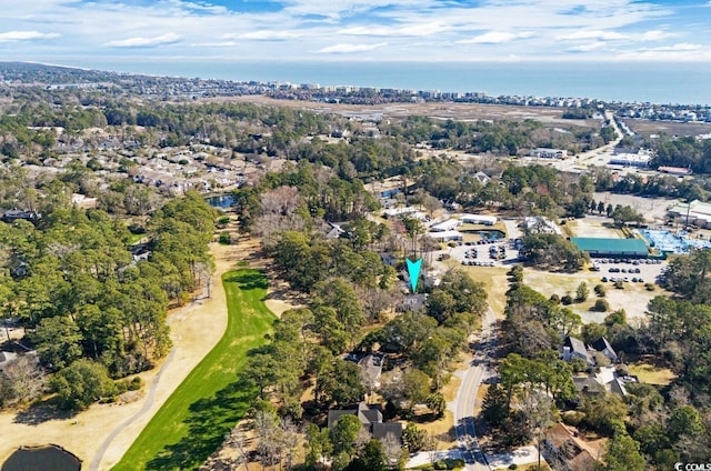 drone / aerial view featuring view of golf course and a water view