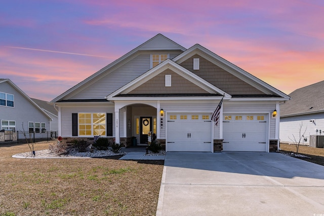 craftsman house with stone siding, cooling unit, concrete driveway, and fence